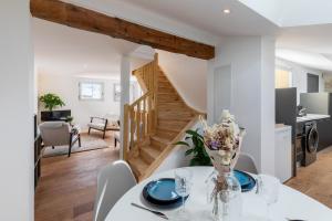 a kitchen and living room with a dining table and a staircase at Le Panorama - Rooftop & Climatisation in Montpellier