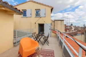 a balcony with chairs and a table on a building at Le Panorama - Rooftop & Climatisation in Montpellier +11 photos