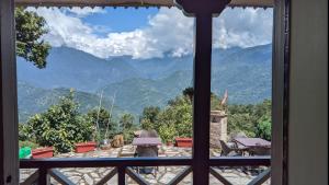 a view from a window of a mountain view at MayaTels - Maya Eco Huts, Pelling in Pelling