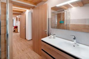 a bathroom with a sink and a mirror at La Casa di Bryan in Piaia +16 photos