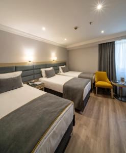 A bed or beds in a room at Amethyst Hotel