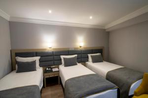 A bed or beds in a room at Amethyst Hotel