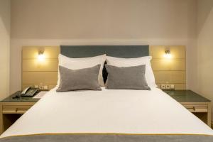 A bed or beds in a room at Amethyst Hotel