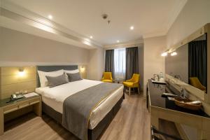 A bed or beds in a room at Amethyst Hotel