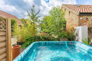 a swimming pool in the backyard of a house at the Orangery Suites in Thurning