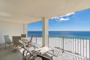 a balcony with chairs and a view of the ocean at Windward Pointe 803 in Orange Beach