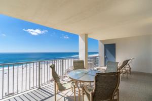 a balcony with a table and chairs and the ocean at Windward Pointe Condominiums in Orange Beach