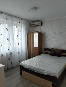a bedroom with a bed and white walls at Apartament BIS in Buzau