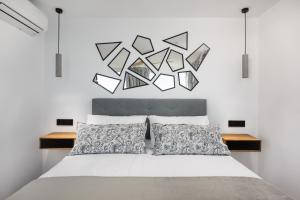 a bedroom with a bed with a white wall at Perla Negra - Apartment with Private Beach Access in Benalmádena