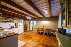 a kitchen and dining room with a table and chairs at Chalupa pod Sixovkou in Krupina