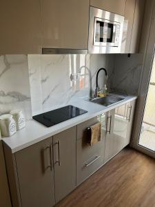 a kitchen with a sink and a counter top at La Maison in Patra