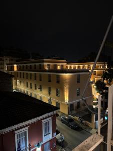 a view of a building at night with lights at La Maison in Patra