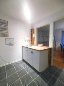 a kitchen with a counter and a sink in a room at Villa Stone House Lappland in Norsjö