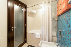 a bathroom with a shower and a sink and a toilet at Holiday Inn Kuwait Al Thuraya City by IHG in Kuwait +37 photos
