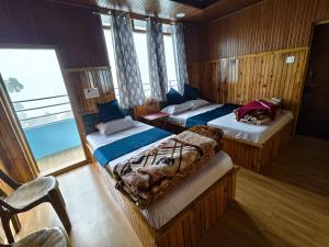 a bedroom with two beds in a boat at Kolakham Nature View Home Stay in Lava