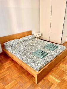 a bedroom with a bed with two towels on it at Downtown Milan Chic Apartment - Quiet Retreat with Free WIFI & Air Conditioning in Milan