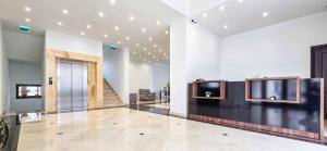 a lobby with a door and a television on a wall at Green Park Boutique Hotel in Focşani