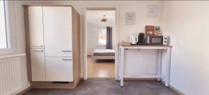 a room with a closet and a desk with a microwave at Apartment Neckarglück in Edingen-Neckarhausen
