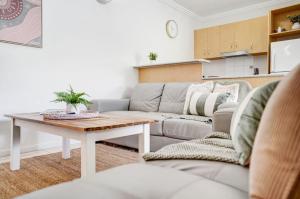 a living room with a couch and a table at 24 Central Plaza Port Douglas in Port Douglas