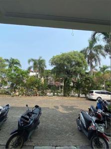a group of motorcycles parked in a parking lot at Awany CoLiving in Jakarta +9 photos