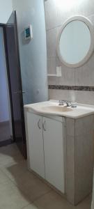 a bathroom with a white sink and a mirror at JuLuc Trelew dpto 1 TUCCI in Trelew +40 photos