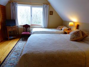 A bed or beds in a room at Camillaun Lodge with Lough Corrib Boat Hire