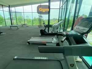 a gym with cardio equipment in a building at Gardens peace Hatyai in Hat Yai