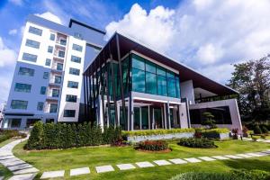a large building with a garden in front of it at Gardens peace Hatyai in Hat Yai