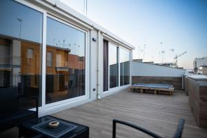 a balcony with a bench and large windows at impulses home suite idromassaggio in Barletta