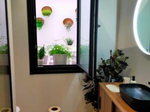 Un baño con una ventana con plantas en macetas. en Alojamiento Beach Riazor, en A Coruña 40 fotos más