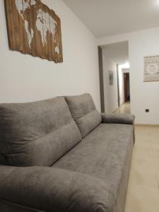 a couch in a living room with a picture on the wall at Casa Mila in Puerto del Rosario