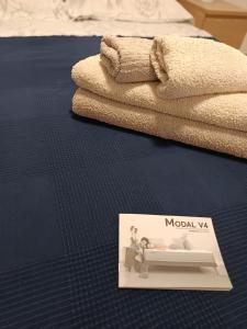 a picture of a bed with a magazine on the floor at Casa Mila in Puerto del Rosario