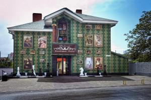 a green building with pictures on the side of it at Weekend Boutique Hotel in Chişinău