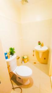 a bathroom with a toilet and a sink at Palacio in Kaybagal +12 photos