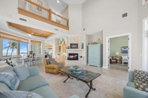 a living room with a couch and a fireplace at Captiva Grace home in Captiva