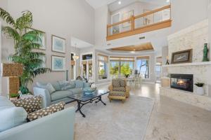 a living room with blue furniture and a fireplace at Captiva Grace home in Captiva