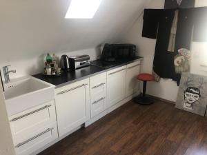 a kitchen with a sink and a counter top at Bel Art Atelier mit großem Parkplatz in Haan