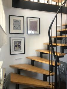 a set of stairs in a room with pictures on the wall at Bel Art Atelier mit großem Parkplatz in Haan