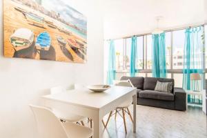 a living room with a white table and chairs at Apartment 5 minutes from the sea in Playa del Ingles