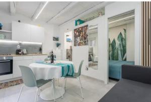 a kitchen with a table and chairs in a kitchen at Apartment al Vicolo 27 in Palermo