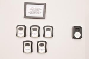 a wall with four cell phones on a wall at Napoli Vitale Apartments in Naples