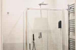 a shower with a glass door in a bathroom at Napoli Vitale Apartments in Naples +130 photos