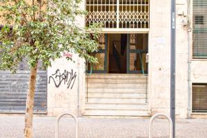 a building with two stools in front of a door at Napoli Vitale Apartments in Naples