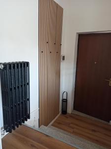 a room with a door and a wooden floor at La casa di Andrea in Cogliate