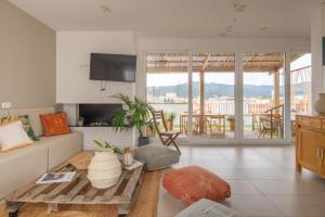a living room with a couch and a table at Hostal Boutique Es Portalet in Sant Feliu de Guixols