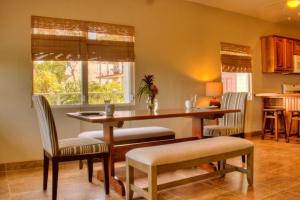a dining room with a table and chairs and a kitchen at Coral House Inn in Punta Gorda