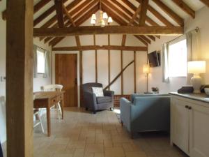a living room with a couch and a table at Acorns in Plaitford