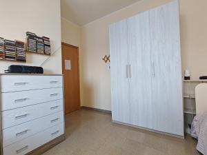 a bedroom with a white dresser and a closet at Villa Iside in Roggiano Gravina