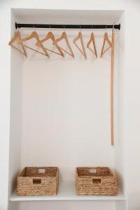 two baskets on a shelf in a white wall at Dimora Maseva - DIEMME STAY in Alberobello