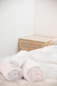 a bed with white sheets and a wooden table at Dimora Maseva - DIEMME STAY in Alberobello